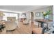 Bright living room features hardwood floors, neutral-toned furniture, and an arched doorway to another room at 717 Carolina Ave, Tarpon Springs, FL 34689