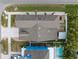 A bird's-eye view of a house with a pool, lush greenery, and a patio at 7602 S Desoto St, Tampa, FL 33616