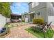 Private backyard with a custom wood pergola over outdoor seating and well maintained landscaping at 7602 S Desoto St, Tampa, FL 33616