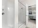 Modern bathroom features a glass-enclosed shower with tile walls, next to the main bedroom at 7602 S Desoto St, Tampa, FL 33616