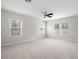 A light and bright bedroom with multiple windows and a ceiling fan at 7602 S Desoto St, Tampa, FL 33616