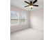This carpeted bedroom is freshly painted with bright, natural light from two windows at 7602 S Desoto St, Tampa, FL 33616