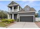 This two-story home boasts a covered front porch, attached garage, and beautifully landscaped yard at 7602 S Desoto St, Tampa, FL 33616