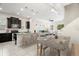Open-concept kitchen with dark cabinets, stainless steel appliances, and granite counters flowing into dining area at 7602 S Desoto St, Tampa, FL 33616