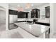 Well-equipped kitchen featuring stainless steel appliances, island with granite countertop, and dark cabinetry at 7602 S Desoto St, Tampa, FL 33616