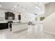 Open-concept kitchen with stainless steel appliances and a large island, seamlessly flowing into the living area at 7602 S Desoto St, Tampa, FL 33616