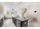 Open-concept kitchen featuring dark cabinets, granite counters, a center island, and an adjoining dining and living space at 7602 S Desoto St, Tampa, FL 33616