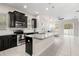 Granite counters pair with stainless steel appliances and dark cabinets in this modern, open kitchen at 7602 S Desoto St, Tampa, FL 33616