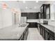 Modern kitchen with granite countertops, stainless steel appliances, and dark cabinetry; perfect for cooking and entertaining at 7602 S Desoto St, Tampa, FL 33616