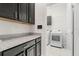 Laundry room featuring granite countertops, and modern washer and dryer units at 7602 S Desoto St, Tampa, FL 33616