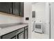 Convenient laundry room with washer, dryer, counter space, and ample storage cabinets at 7602 S Desoto St, Tampa, FL 33616