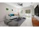 Bright living room with white sofa, a ceiling fan, with access to the backyard through sliding glass doors at 7602 S Desoto St, Tampa, FL 33616