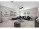 Open living room featuring a large sectional sofa, modern lighting, and multiple windows for abundant natural light at 7602 S Desoto St, Tampa, FL 33616