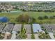An aerial view of the neighborhood, pond and golf course with meticulous landscaping throughout at 1123 Emerald Dunes Dr, Sun City Center, FL 33573