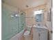 This bathroom features shower/tub combo, white vanity with marble top and tiled flooring at 1123 Emerald Dunes Dr, Sun City Center, FL 33573