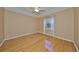 This spacious bedroom features a tray ceiling with fan and natural light with hard wood flooring at 1123 Emerald Dunes Dr, Sun City Center, FL 33573