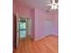View of bedroom with wood flooring, large closet, ceiling fan, and access to additional room at 1123 Emerald Dunes Dr, Sun City Center, FL 33573