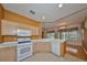 The kitchen is equipped with modern appliances, white countertops, and a breakfast bar that is perfect for quick meals at 1123 Emerald Dunes Dr, Sun City Center, FL 33573