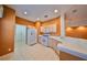 Well-lit kitchen with white appliances and tile flooring, adjacent to a living area, perfect for Gathering gatherings at 1123 Emerald Dunes Dr, Sun City Center, FL 33573