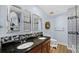 Double sink bathroom with granite countertop, decorative mirrors and updated fixtures at 1209 E Cumberland Ave # 505, Tampa, FL 33602