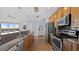 Spacious kitchen with stainless steel appliances, granite countertops, and wood cabinetry at 1209 E Cumberland Ave # 505, Tampa, FL 33602