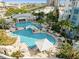 Stunning aerial view of a community pool with palm trees and a charming bridge at 1209 E Cumberland Ave # 505, Tampa, FL 33602