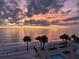 Lovely aerial view of the Gulf at sunset, with palm trees, lounge area and a swimming pool at 16330 Gulf Blvd # 306, Redington Beach, FL 33708