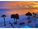 Beautiful aerial view of the beach and Gulf at sunset, with a pool and lounge area at 16330 Gulf Blvd # 306, Redington Beach, FL 33708