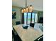Bright dining area with a marble table and view of the ocean from sliding glass doors at 16330 Gulf Blvd # 306, Redington Beach, FL 33708