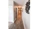 Long hallway with wood flooring and neutral walls leads to the bedrooms and living spaces at 16330 Gulf Blvd # 306, Redington Beach, FL 33708