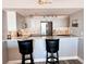 Kitchen with stainless appliances, stone backsplash, granite counters, and bar seating at 16330 Gulf Blvd # 306, Redington Beach, FL 33708
