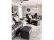 Living room featuring wood-look floors, comfortable seating, a dining area, and modern decor at 16330 Gulf Blvd # 306, Redington Beach, FL 33708