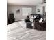 Cozy living room with leather seating, TV, and sliding glass door access at 16330 Gulf Blvd # 306, Redington Beach, FL 33708