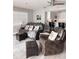 Living room with comfortable leather seating, beach-themed decor, and view into the kitchen at 16330 Gulf Blvd # 306, Redington Beach, FL 33708