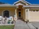 Close-up of a lovely front porch featuring seating and meticulous landscaping, located near the home's 2-car garage at 17413 Eagle Trace Dr, Brooksville, FL 34604