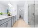 Modern bathroom featuring a glass door shower, dual sink vanity, and light wood flooring at 31349 Cabana Rye Ave, San Antonio, FL 33576