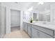 Bathroom featuring double sinks, a large mirror and glass enclosed shower and walk-in closet at 31349 Cabana Rye Ave, San Antonio, FL 33576