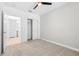 Bedroom featuring neutral carpet, ceiling fan, closet, and view of the bathroom at 31349 Cabana Rye Ave, San Antonio, FL 33576
