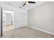 Bedroom featuring neutral carpet, ceiling fan, closet, and view of the bathroom at 31349 Cabana Rye Ave, San Antonio, FL 33576