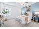 Bright bedroom featuring neutral carpet, ceiling fan and a serene accent wall at 31349 Cabana Rye Ave, San Antonio, FL 33576