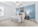 Cozy bedroom featuring neutral carpet, ceiling fan and a serene accent wall at 31349 Cabana Rye Ave, San Antonio, FL 33576