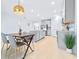 Bright, open kitchen and dining area with modern light gray cabinets and a stylish wood dining table at 31349 Cabana Rye Ave, San Antonio, FL 33576