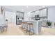 Bright, open kitchen with a central island and breakfast bar and stainless steel appliances at 31349 Cabana Rye Ave, San Antonio, FL 33576