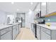 Contemporary kitchen with an island, stainless steel appliances and light gray cabinetry at 31349 Cabana Rye Ave, San Antonio, FL 33576