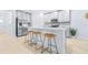 Stylish kitchen island with seating, stainless steel appliances, and bright neutral decor at 31349 Cabana Rye Ave, San Antonio, FL 33576
