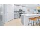 Open kitchen area with a center island, light gray cabinetry, and a stylish blue backsplash at 31349 Cabana Rye Ave, San Antonio, FL 33576