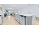 Open concept kitchen with stainless steel dishwasher and oversized island featuring a sink at 31349 Cabana Rye Ave, San Antonio, FL 33576