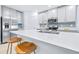 Modern kitchen island with bright countertops, seating, and stainless steel sink at 31349 Cabana Rye Ave, San Antonio, FL 33576