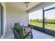 Screened-in patio with comfortable seating and a ceiling fan overlooks a lush, green backyard at 31349 Cabana Rye Ave, San Antonio, FL 33576