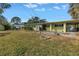 Expansive backyard with lush greenery, patio, and mature trees creating a serene outdoor space at 6170 7Th N Ave, St Petersburg, FL 33710